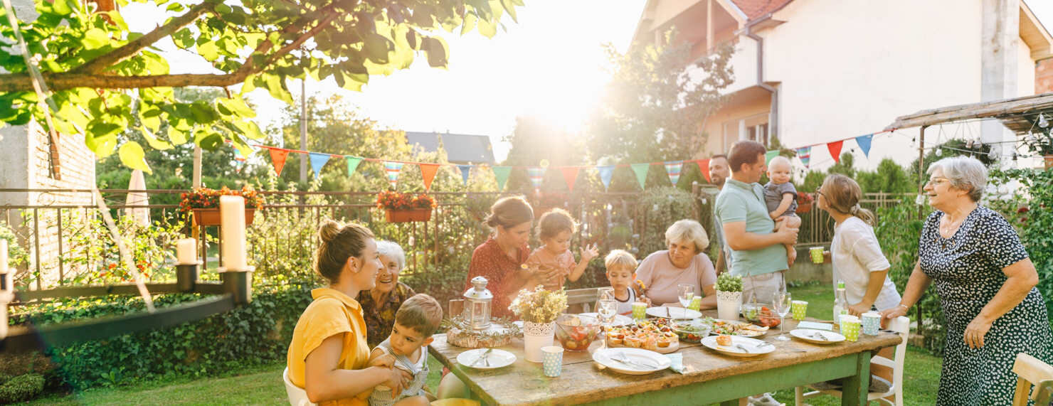 IDEAL Hausratversicherung: Frau und Mann lachen in der Küche beim Kochen