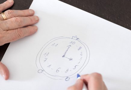 Eine Nahaufnahme von einem DIN A4 Blatt, auf dem Eine Uhr gezeichnet wurde